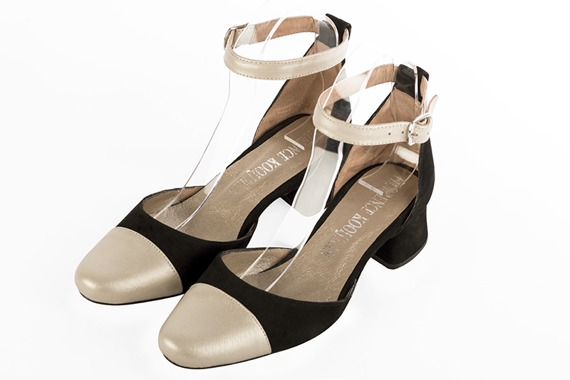 Gold and matt black women's open side shoes, with a strap around the ankle. Round toe. Low flare heels. Front view - Florence KOOIJMAN